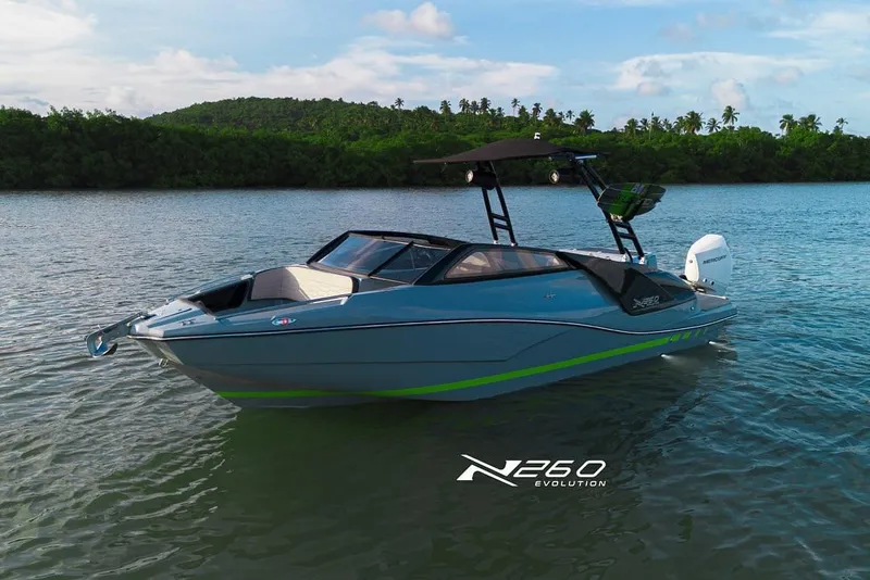 Slide: The Image of 2025 NX Boats NX260 EVOLUTION on serene water with lush green backdrop. - 7
