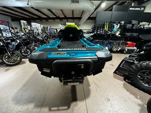 Slide: The Image of 2025 Sea-Doo GTI SE 170 jet ski displayed in a showroom with various vehicles. - 13