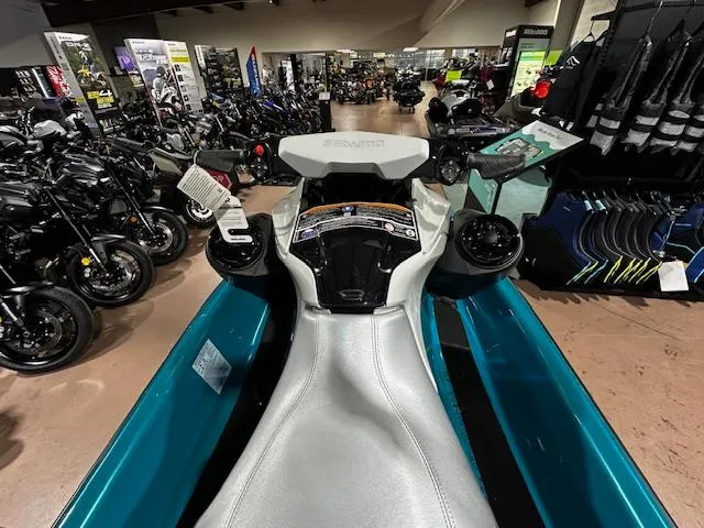 Slide: The Image of 2025 Sea-Doo GTI SE 170 jet ski displayed in a showroom with motorcycles. - 16