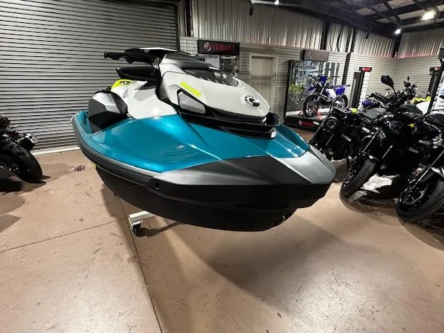 Slide: The Image of 2025 Sea-Doo GTI SE 170 jet ski displayed in a showroom with motorcycles. - 6