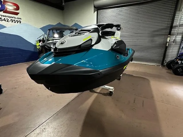 Slide: The Image of 2025 Sea-Doo GTI SE 170 jet ski in showroom, teal and black design. - 8