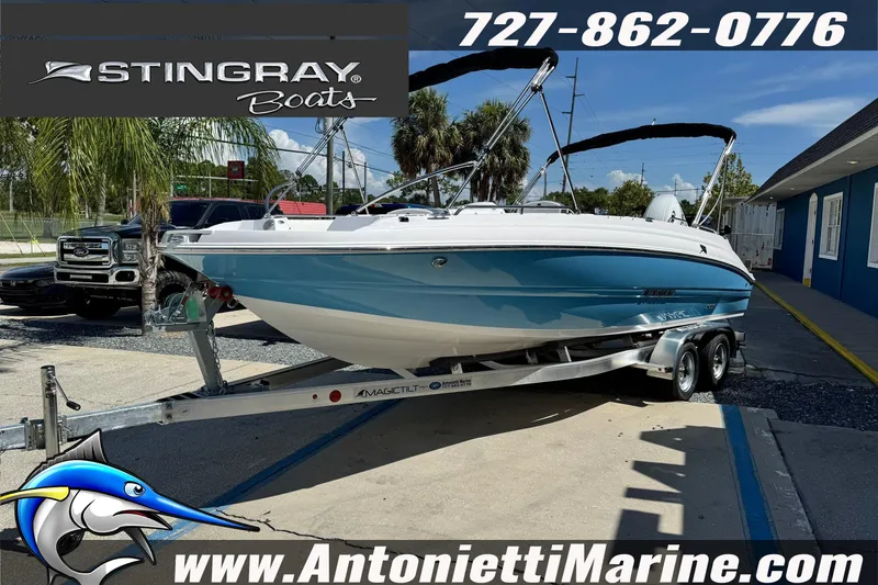 The Image of 2026 Stingray 212 SC boat on trailer at Antonietti Marine dealership. - 1
