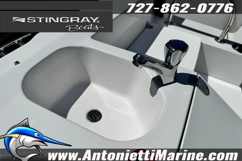 Slide: The Image of 2026 Stingray 212 SC boat sink with faucet, featuring Stingray Boats branding and contact information. - 24