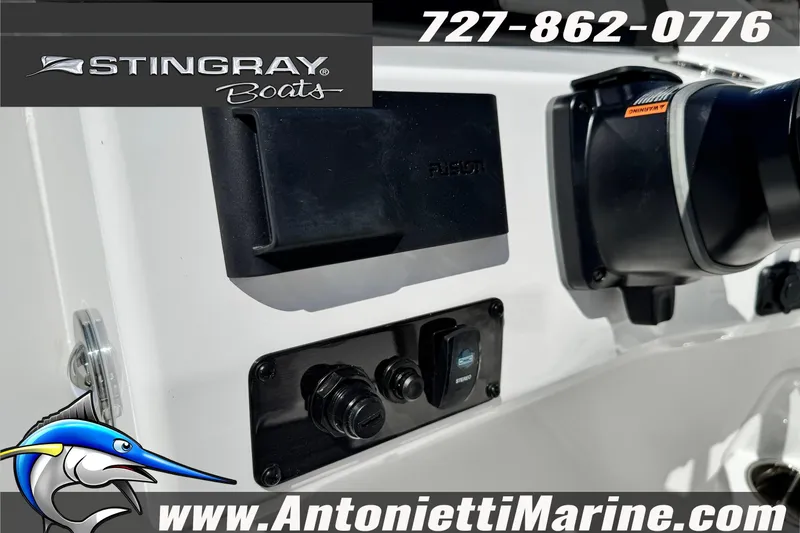 Slide: The Image of 2026 Stingray 212 SC boat dashboard with controls and branding details. - 26