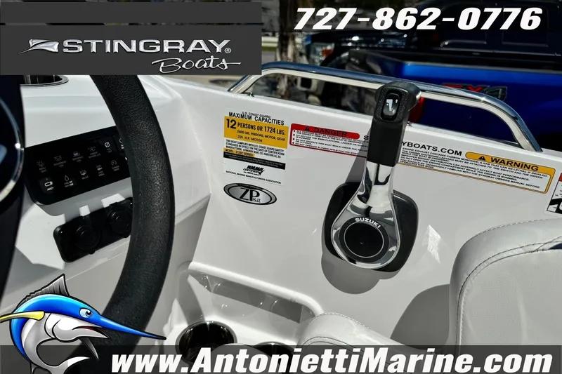 Slide: The Image of 2026 Stingray 212 SC boat dashboard with controls and capacity warning labels. - 27