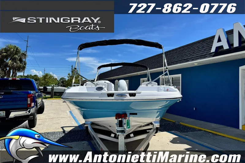 Slide: The Image of 2026 Stingray 212 SC boat on trailer at Antonietti Marine dealership. - 3