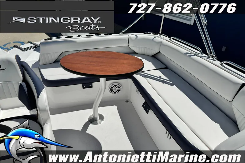 Slide: The Image of 2026 Stingray 212 SC boat interior with seating and table, featuring Antonietti Marine branding. - 36