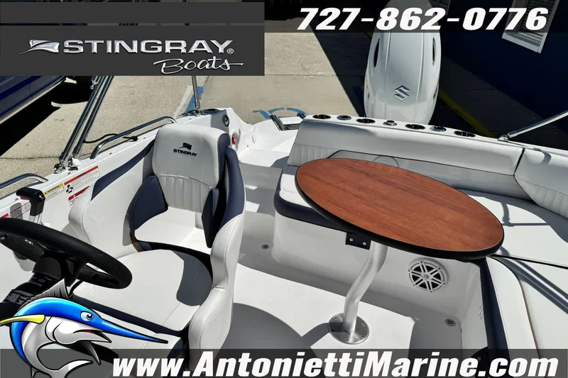 Slide: The Image of 2026 Stingray 212 SC boat interior with seating and table, featuring Antonietti Marine branding. - 37