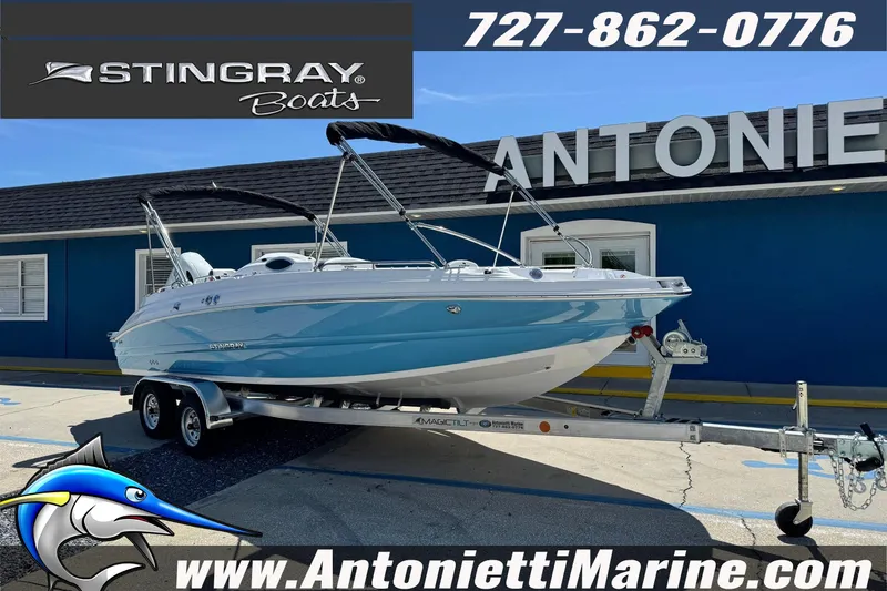 Slide: The Image of 2026 Stingray 212 SC boat on trailer at Antonietti Marine dealership. - 4
