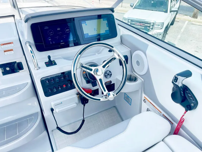 Slide: The Image of 2024 Regal 26XO boat helm with modern controls and steering wheel. - 7