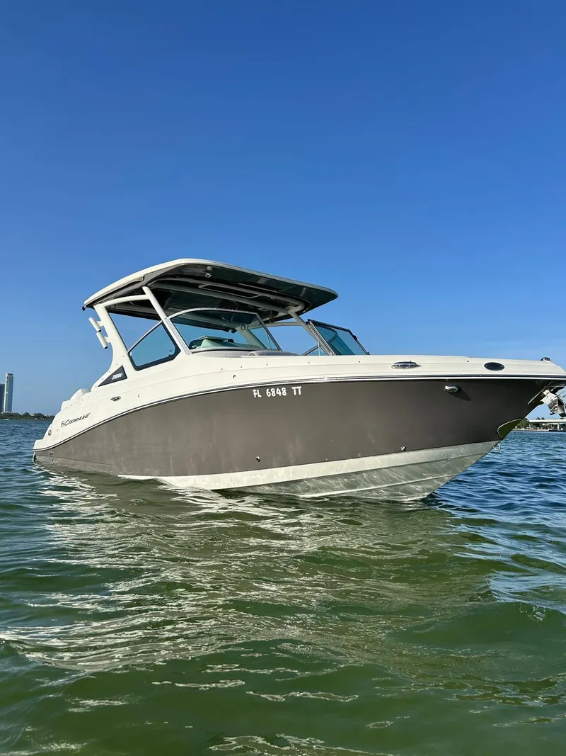 The Image of 2024 Crownline 260DC boat on water, featuring sleek design and powerful Mercury outboard engine. - 0