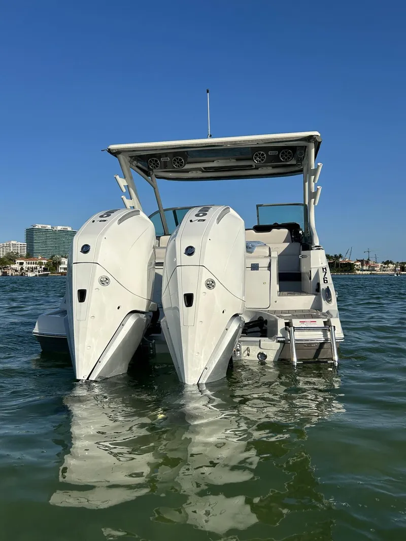 Slide: The Image of 2024 Crownline 260DC boat with dual outboard engines on water. - 11