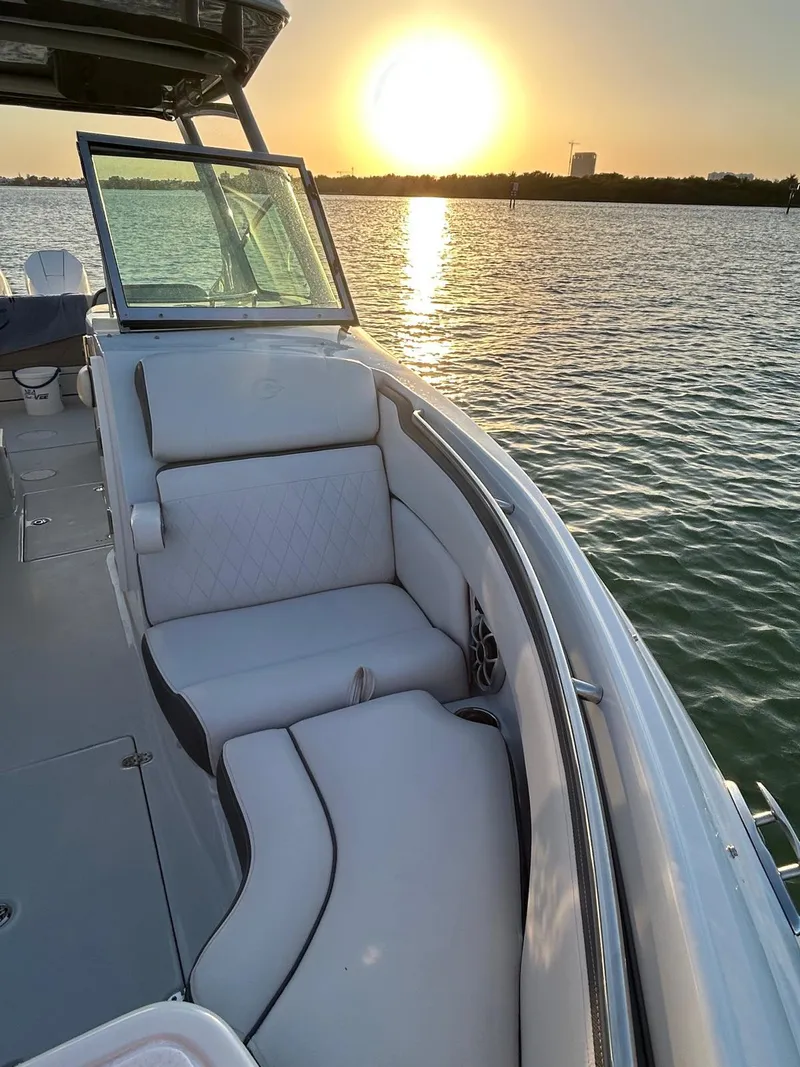 Slide: The Image of 2024 Crownline 260DC boat interior with sunset view over the water. - 12