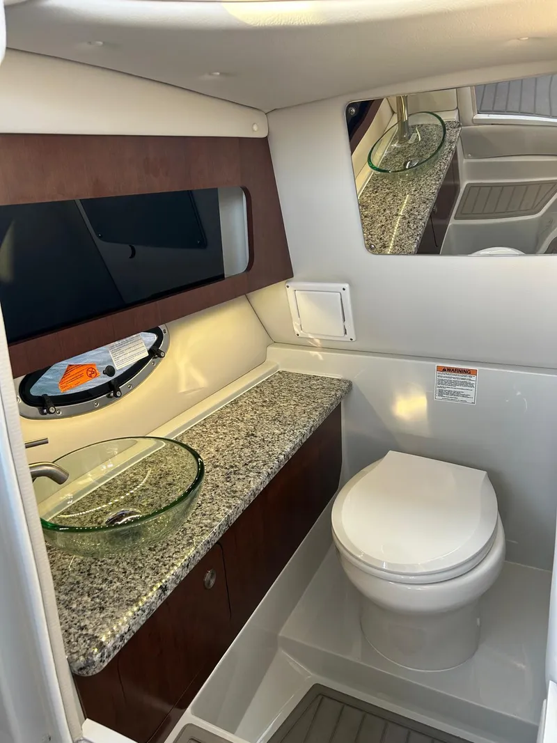 Slide: The Image of Luxurious bathroom interior of 2024 Crownline 260DC boat with granite countertop and modern fixtures. - 14
