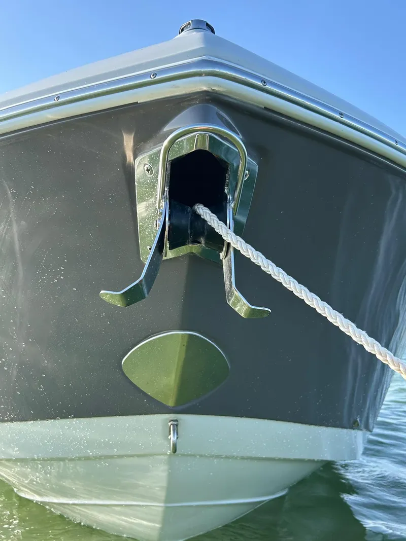 Slide: The Image of 2024 Crownline 260DC boat on water under bright sun. - 3