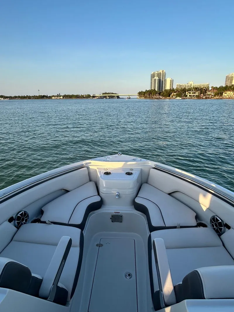 Slide: The Image of 2024 Crownline 260DC boat interior with waterfront cityscape view. - 5