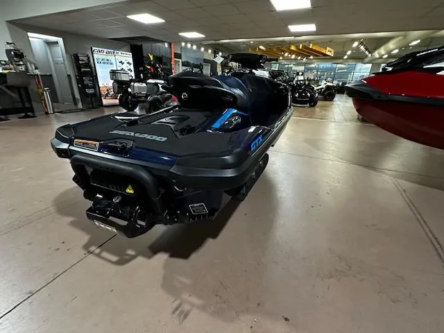 Slide: The Image of 2025 Sea-Doo GTX 230 jet ski displayed in a showroom, rear view. - 11