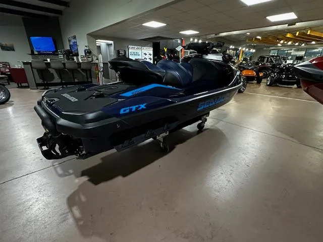 Slide: The Image of 2025 Sea-Doo GTX 230 jet ski displayed in a showroom setting. - 12