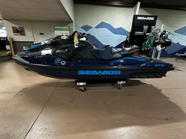 Slide: The Image of 2025 Sea-Doo GTX 230 jet ski displayed indoors, showcasing sleek design and branding. - 7