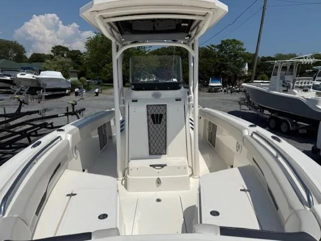 Slide: The Image of 2018 Wellcraft 222 Fisherman boat interior with seating and console, parked in a marina. - 11