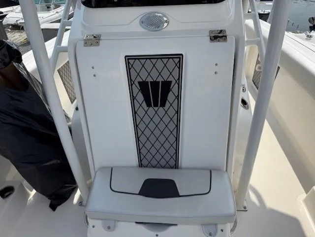 Slide: The Image of 2018 Wellcraft 222 Fisherman boat interior with cushioned seating and storage. - 12