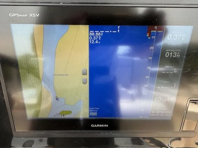 Slide: The Image of Garmin GPSMAP XSV display on 2018 Wellcraft 222 Fisherman boat, showing navigation and depth data. - 18
