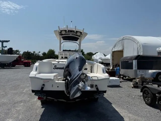 Slide: The Image of 2018 Wellcraft 222 Fisherman boat with outboard motor in a storage yard. - 4