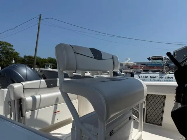 Slide: The Image of 2018 Wellcraft 222 Fisherman boat interior with seating and maintenance area. - 9