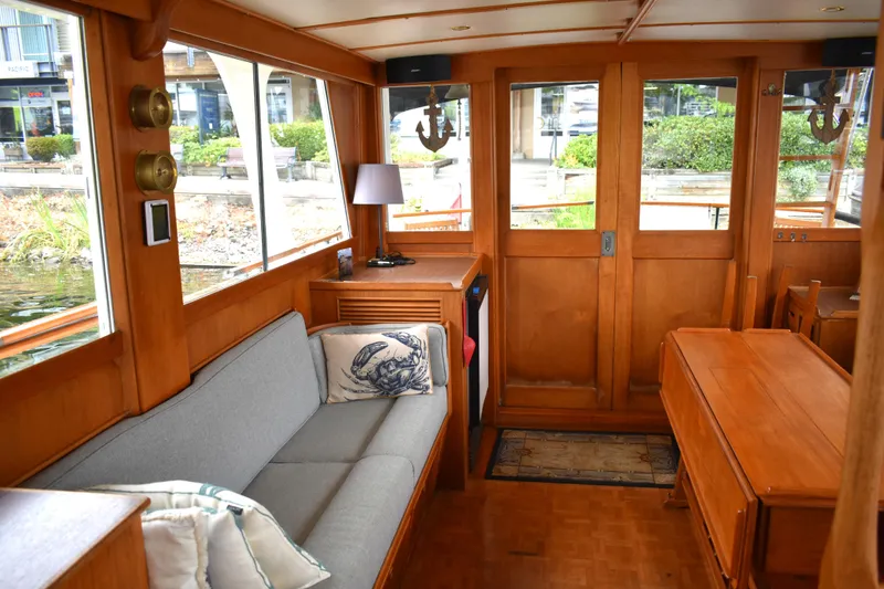 Slide: The Image of Interior of 1980 Grand Banks 42 Europa yacht, featuring wooden decor and cozy seating. - 10