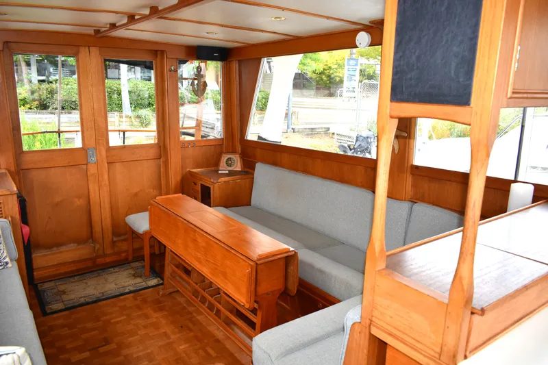 Slide: The Image of Interior of 1980 Grand Banks 42 Europa yacht with wooden furnishings and gray seating. - 11