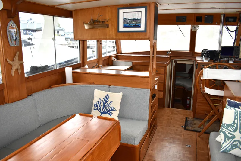 Slide: The Image of Interior of 1980 Grand Banks 42 Europa yacht with wooden decor and cozy seating area. - 12