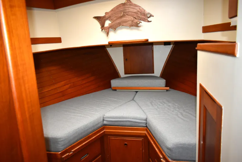 Slide: The Image of Interior cabin of 1980 Grand Banks 42 Europa with wooden finish and fish wall decor. - 14