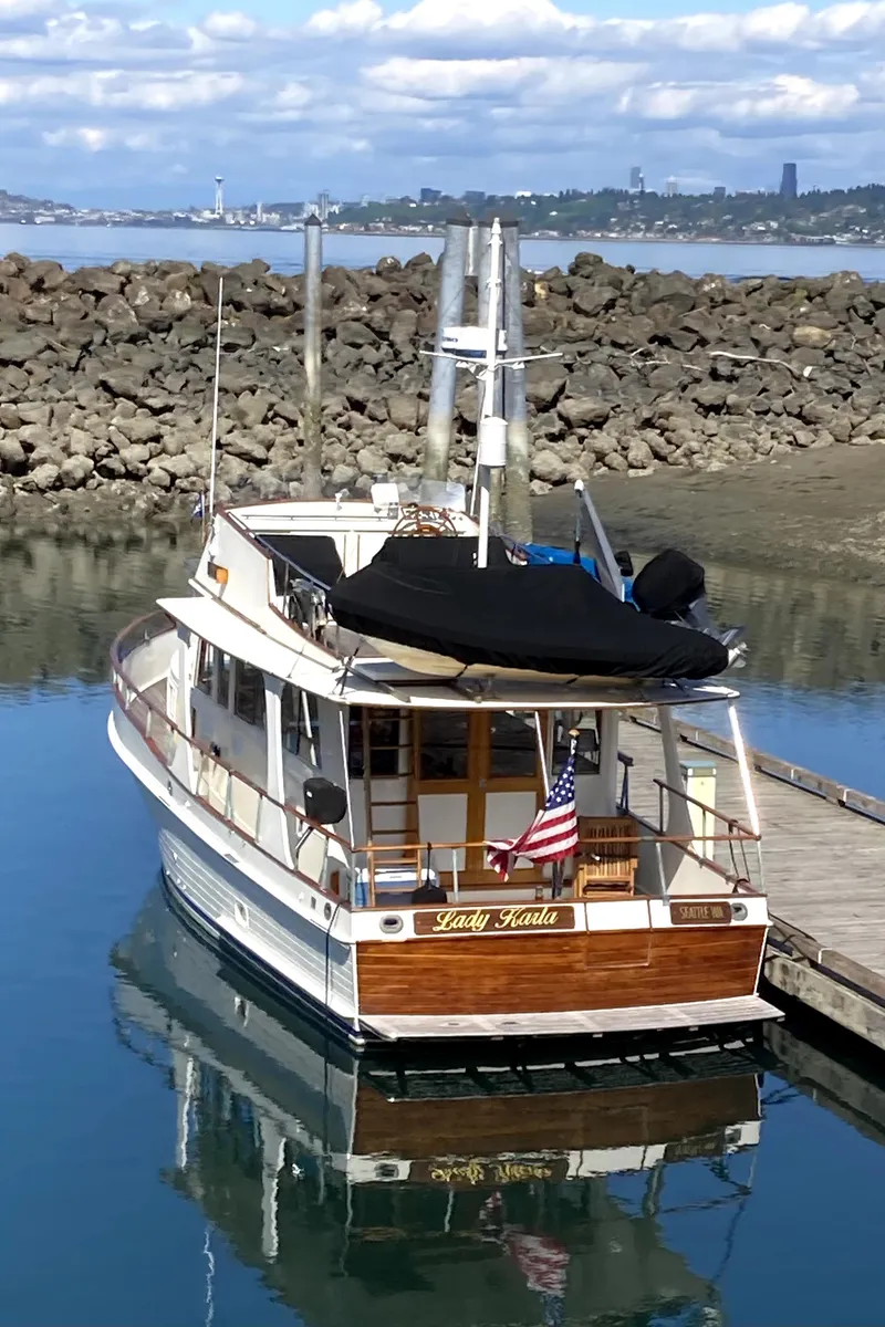 Slide: The Image of 1980 Grand Banks 42 Europa yacht docked in a serene marina setting. - 2