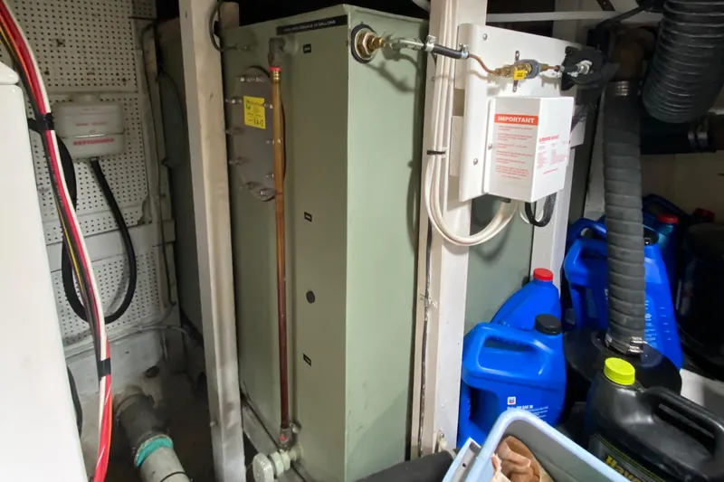 Slide: The Image of Engine room of 1980 Grand Banks 42 Europa with equipment and containers. - 22