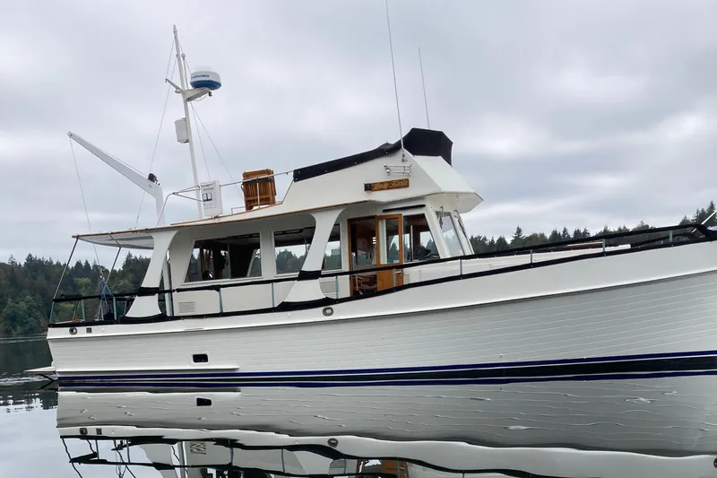 Slide: The Image of 1980 Grand Banks 42 Europa yacht on calm water, overcast sky. - 3