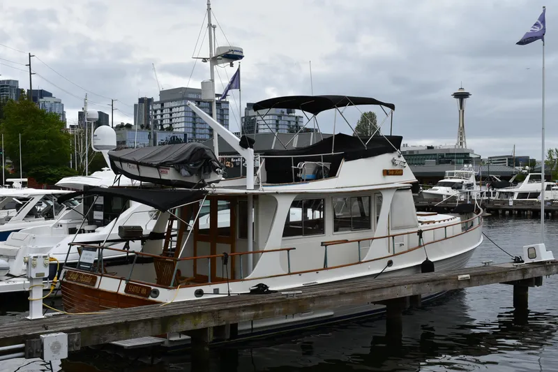 Slide: The Image of 1980 Grand Banks 42 Europa yacht docked in Seattle marina with cityscape background. - 4