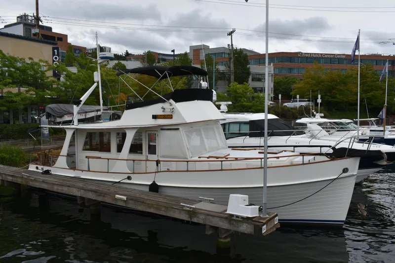 Slide: The Image of 1980 Grand Banks 42 Europa yacht docked at a marina, surrounded by other boats. - 5