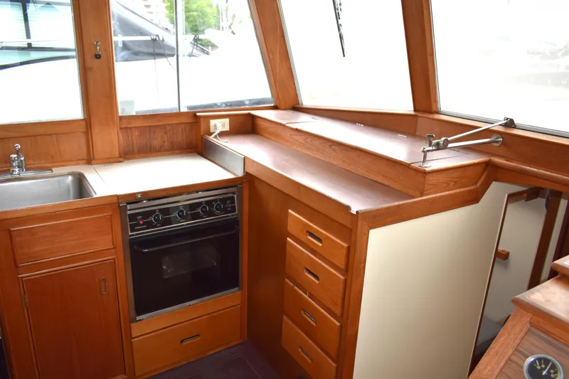 Slide: The Image of Interior of 1980 Grand Banks 42 Europa yacht kitchen with wood cabinetry and oven. - 8