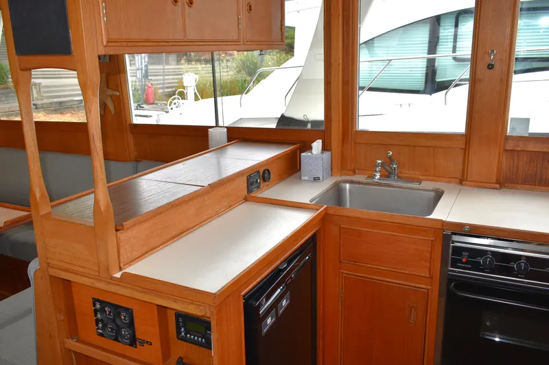 Slide: The Image of Interior of 1980 Grand Banks 42 Europa yacht kitchen with wood cabinetry and appliances. - 9