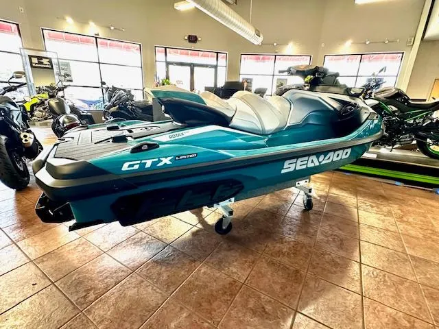 Slide: The Image of 2025 Sea-Doo GTX Limited 325 jet ski displayed in showroom, teal and black design. - 12