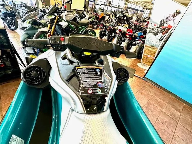 Slide: The Image of 2025 Sea-Doo GTX Limited 325 on display in a showroom with various vehicles. - 13