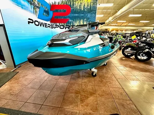 Slide: The Image of 2025 Sea-Doo GTX Limited 325 in showroom, turquoise and black design, displayed at D2 Powersports. - 5