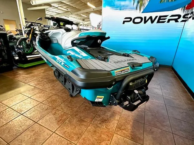 Slide: The Image of 2025 Sea-Doo GTX Limited 325 jet ski displayed in showroom, teal and black design. - 9