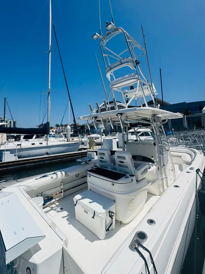 Slide: The Image of 2007 Boston Whaler 320 Outrage boat docked at marina under clear blue sky. - 10