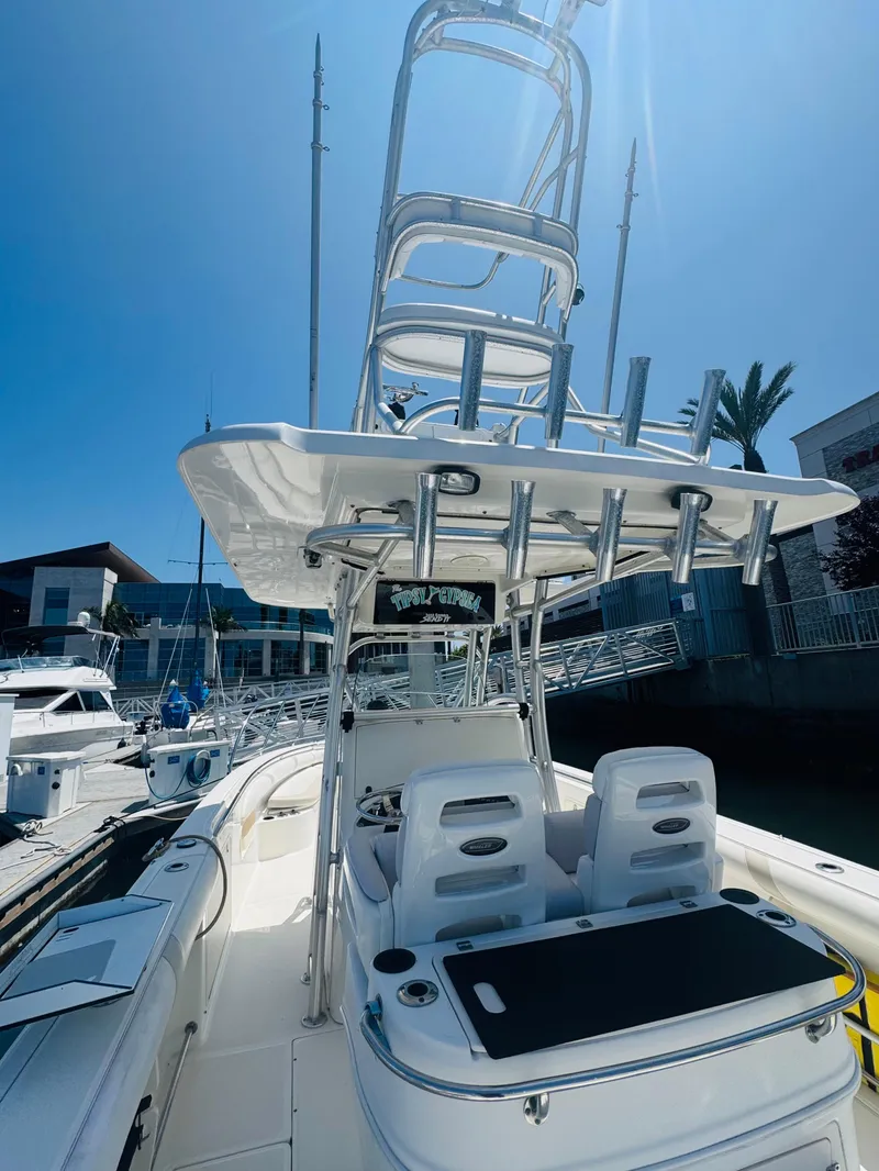 Slide: The Image of 2007 Boston Whaler 320 Outrage boat docked under clear blue sky. - 12