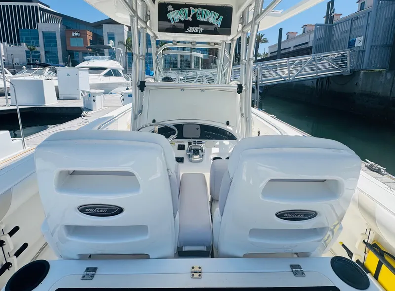 Slide: The Image of 2007 Boston Whaler 320 Outrage boat interior with dual seats at marina. - 13