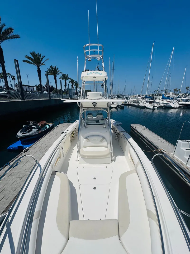 Slide: The Image of 2007 Boston Whaler 320 Outrage docked in a marina, clear blue sky. - 16