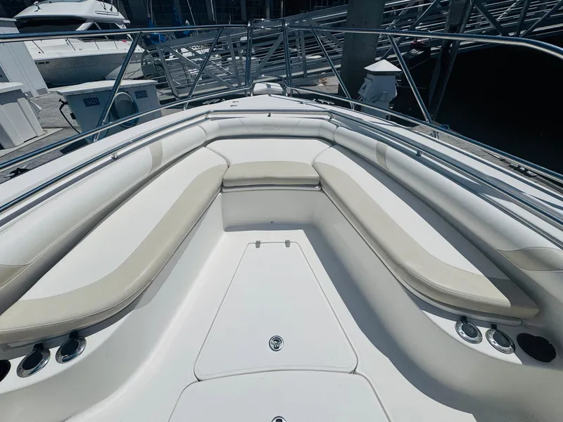 Slide: The Image of 2007 Boston Whaler 320 Outrage boat interior with cushioned seating and stainless steel railings. - 17