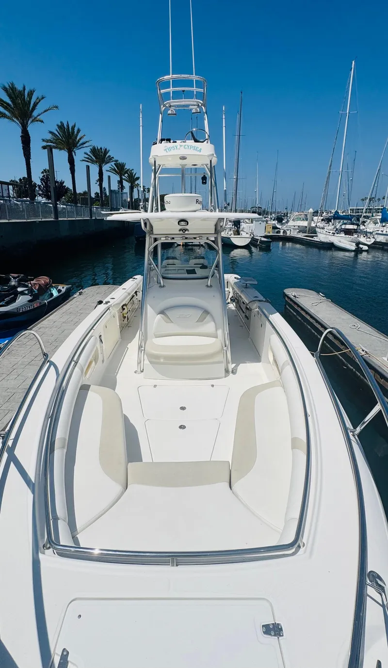Slide: The Image of 2007 Boston Whaler 320 Outrage boat docked in a marina, clear blue sky. - 18