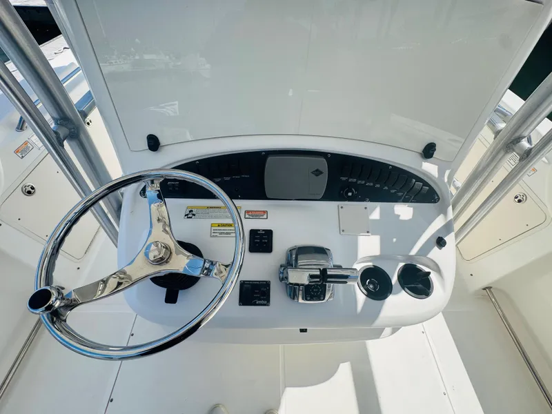 Slide: The Image of 2007 Boston Whaler 320 Outrage helm with steering wheel and controls. - 19